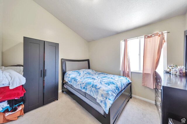 637 W Chase Ln, Centerville, UT 84014 - bedroom with vaulted ceiling, light carpet, and a textured ceiling