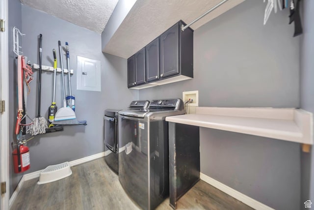 637 W Chase Ln, Centerville, UT 84014 - laundry area featuring cabinet space, electric panel, washer and clothes dryer, wood finished floors, and a textured ceiling