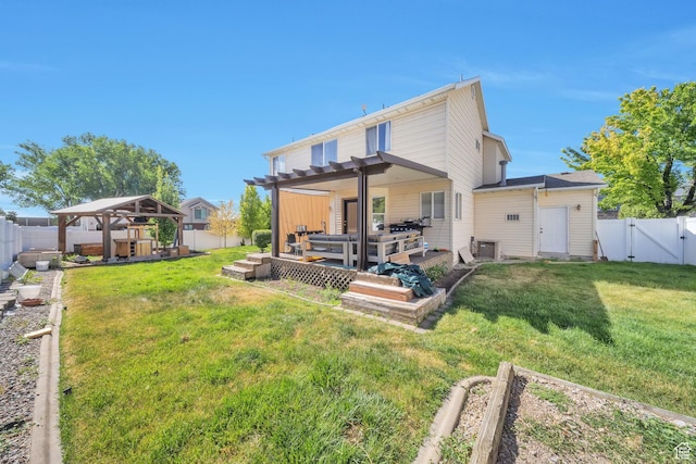 637 W Chase Ln, Centerville, UT 84014 - back of house with a gazebo, a deck, a fenced backyard, a vegetable garden, and a gate