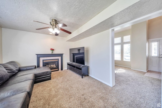 637 W Chase Ln, Centerville, UT 84014 - living room featuring a textured ceiling, a tile fireplace, light carpet, and a ceiling fan