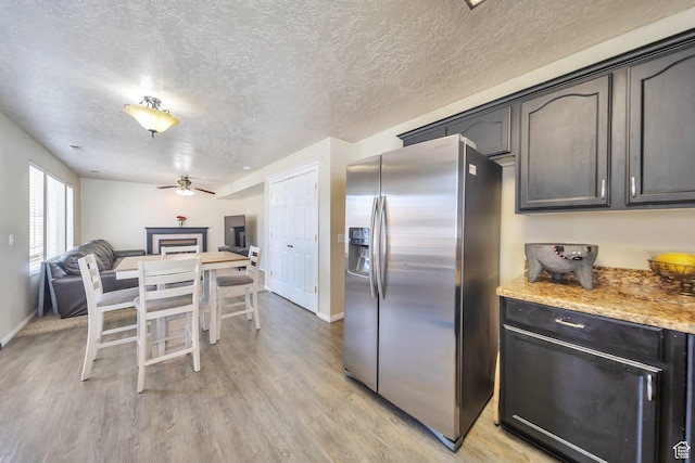 637 W Chase Ln, Centerville, UT 84014 - kitchen with stainless steel fridge, a textured ceiling, light wood finished floors, ceiling fan, and open floor plan