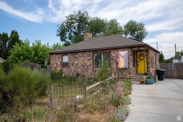 322 E Crawford Ave, Murray, UT 84107 - view of front of home with a chimney, stone siding, and a shingled roof