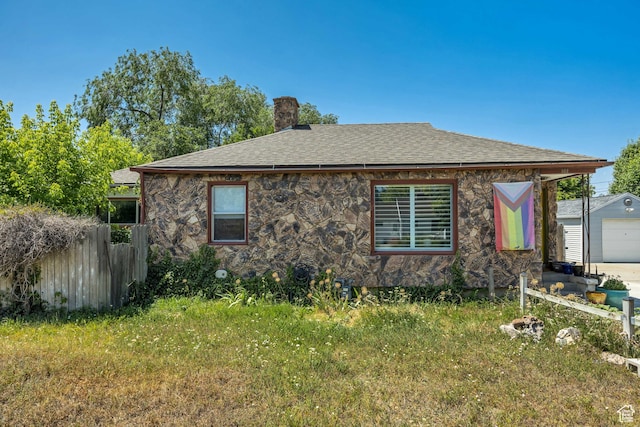 322 E Crawford Ave, Murray, UT 84107 - view of home's exterior featuring a chimney, stone siding, and roof with shingles