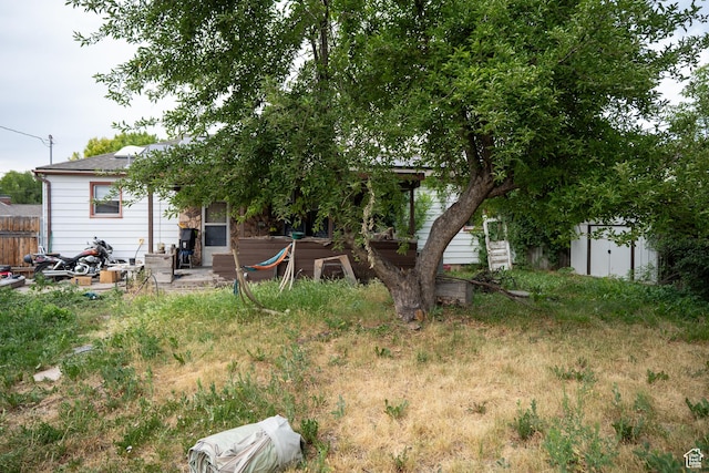 322 E Crawford Ave, Murray, UT 84107 - rear view of property featuring a storage shed and a patio area