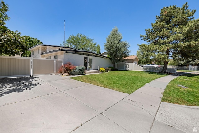 6764 S Enchanted Dr E, Midvale, UT 84047 - mid-century modern home featuring a gate