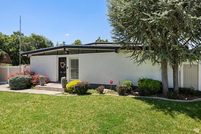 6764 S Enchanted Dr E, Midvale, UT 84047 - rear view of property featuring brick siding