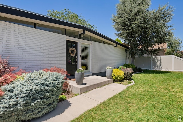 6764 S Enchanted Dr E, Midvale, UT 84047 - doorway to property featuring brick siding