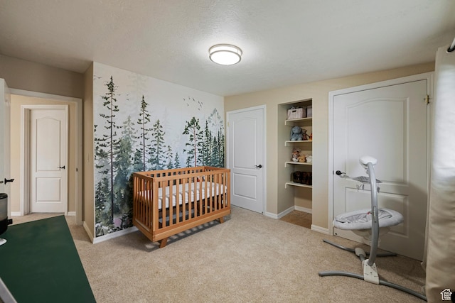 6764 S Enchanted Dr E, Midvale, UT 84047 - bedroom with carpet, a textured ceiling, and a crib