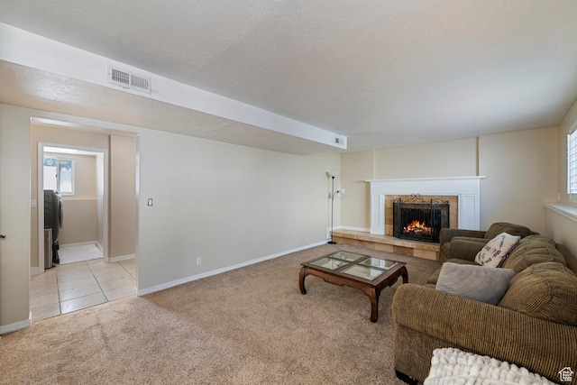 6764 S Enchanted Dr E, Midvale, UT 84047 - living area featuring light colored carpet, a premium fireplace, healthy amount of natural light, and light tile patterned floors
