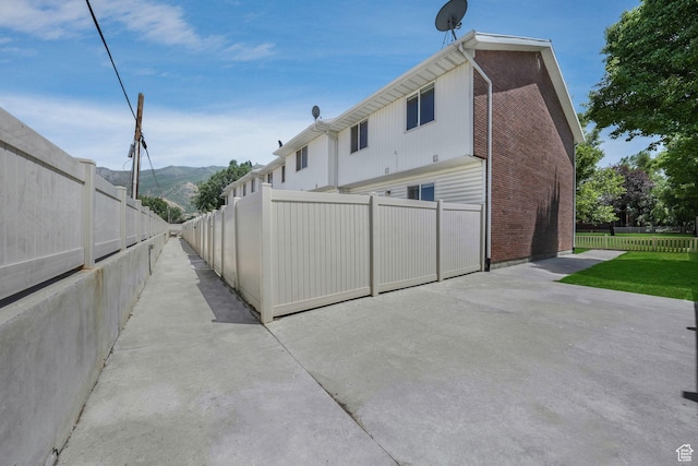 153 E Main St Unit B, Santaquin, UT 84655 - rear view of property with a mountain view, a patio area, and brick siding