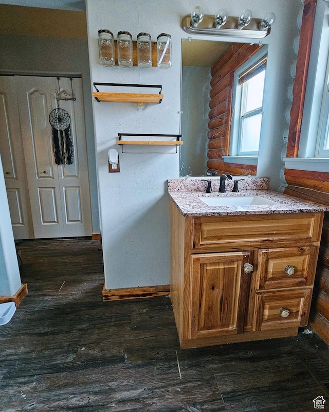 268 W Peach St, Grantsville, UT 84029 - bathroom with log walls, wood finished floors, and vanity