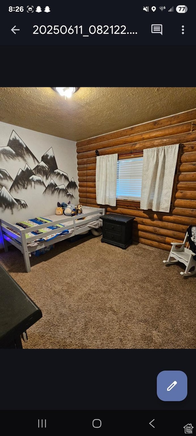268 W Peach St, Grantsville, UT 84029 - bedroom with log walls, carpet floors, and a textured ceiling