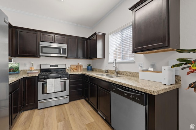 13574 S Cantania Way, Draper, UT 84020 - kitchen featuring appliances with stainless steel finishes, dark brown cabinets, light wood-style flooring, and crown molding