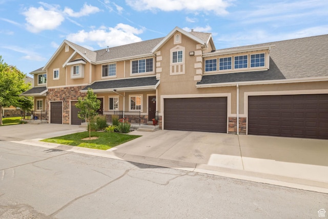 13574 S Cantania Way, Draper, UT 84020 - view of property with stone siding, driveway, a garage, and stucco siding