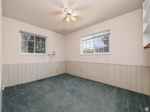 550 S 700 W, Payson, UT 84651 - spare room featuring wooden walls, carpet floors, wainscoting, a textured ceiling, and ceiling fan