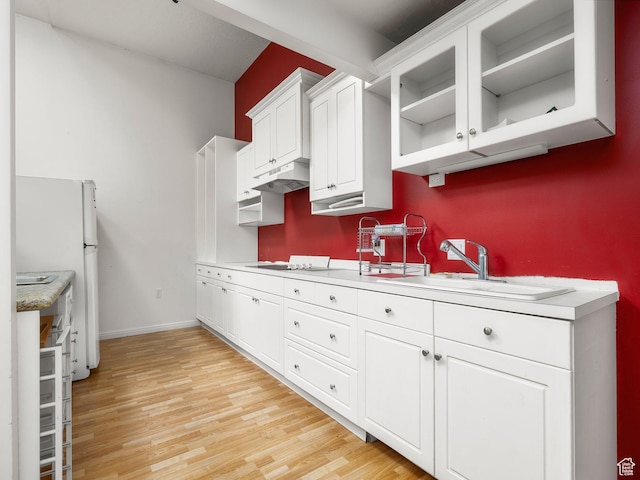 550 S 700 W, Payson, UT 84651 - kitchen with light countertops, white cabinets, light wood-style flooring, and glass insert cabinets