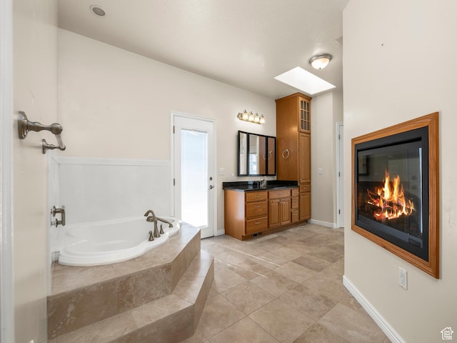 550 S 700 W, Payson, UT 84651 - full bath with vanity, a bath, a glass covered fireplace, and tile patterned flooring