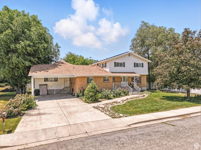550 S 700 W, Payson, UT 84651 - view of front facade with a front lawn, brick siding, concrete driveway, an attached carport, and a porch