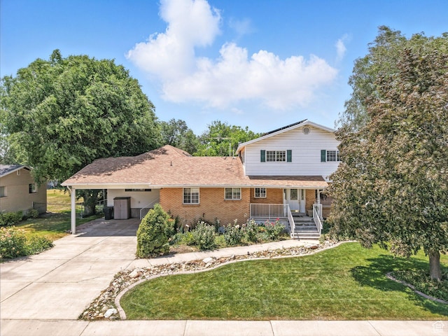 550 S 700 W, Payson, UT 84651 - view of front of property with brick siding, a front yard, driveway, and a carport