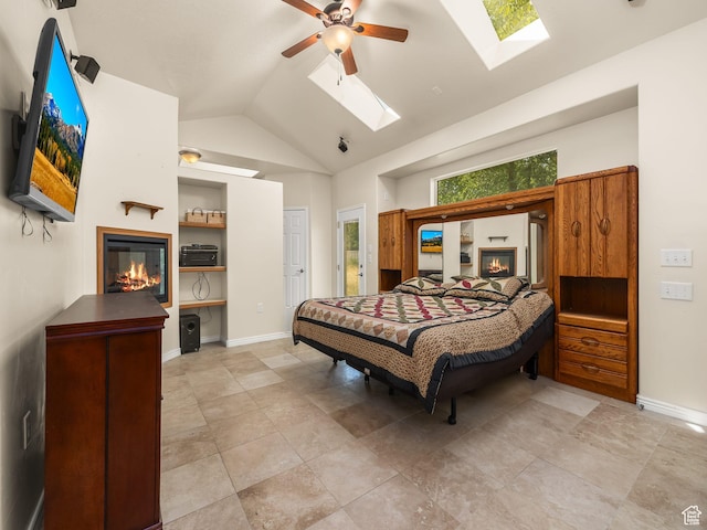 550 S 700 W, Payson, UT 84651 - bedroom featuring a glass covered fireplace, a skylight, lofted ceiling, and a ceiling fan