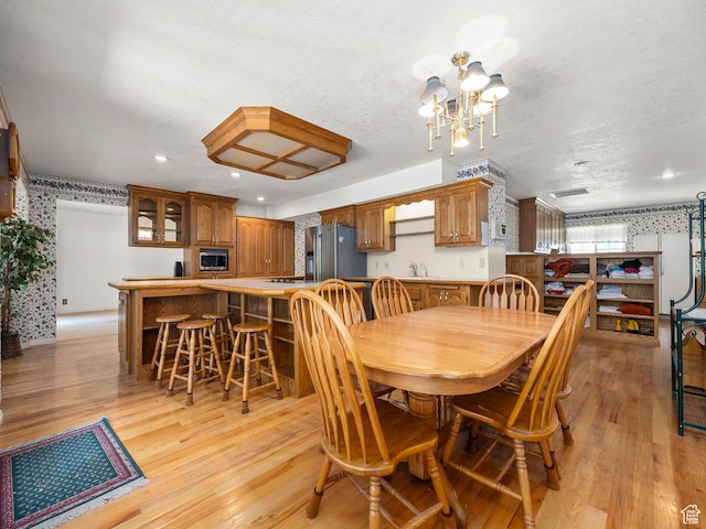 550 S 700 W, Payson, UT 84651 - dining area with light wood-style flooring, a chandelier, recessed lighting, wallpapered walls, and a textured ceiling
