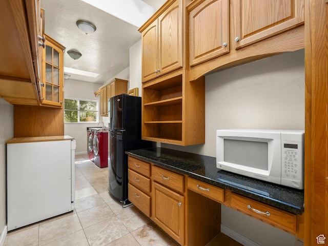 550 S 700 W, Payson, UT 84651 - kitchen with white microwave, freestanding refrigerator, independent washer and dryer, light tile patterned floors, and dark stone countertops