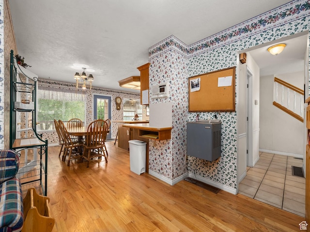550 S 700 W, Payson, UT 84651 - dining area featuring wallpapered walls, light wood-style flooring, a chandelier, stairs, and a textured ceiling