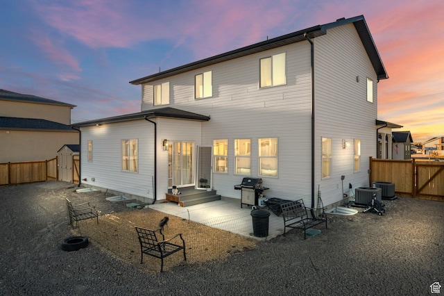 585 W 20 N, Hyrum, UT 84319 - back of house at dusk with a shed, a fenced backyard, and a patio area