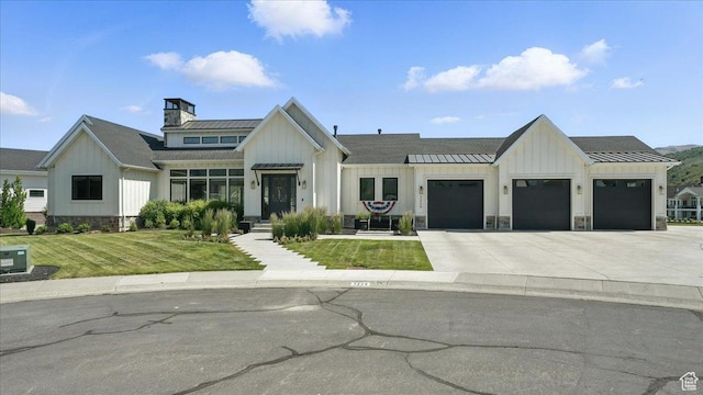 3224 Farm Ridge Ct, Mountain Green, UT 84050 - modern inspired farmhouse with board and batten siding, a standing seam roof, driveway, a garage, and a front lawn