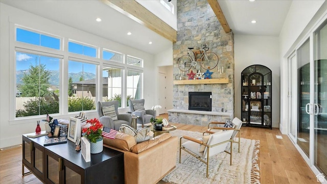 3224 Farm Ridge Ct, Mountain Green, UT 84050 - living room featuring beam ceiling, plenty of natural light, light wood-type flooring, a fireplace, and high vaulted ceiling