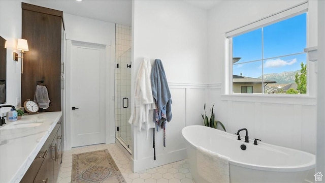 3224 Farm Ridge Ct, Mountain Green, UT 84050 - bathroom with a freestanding tub, a shower stall, healthy amount of natural light, double vanity, and wainscoting