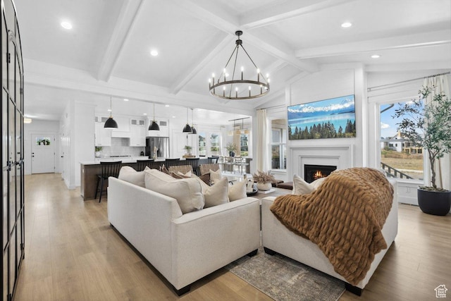 11449 S Bingham Rim Rd, South Jordan, UT 84009 - living area with a chandelier, a lit fireplace, light wood-type flooring, and recessed lighting