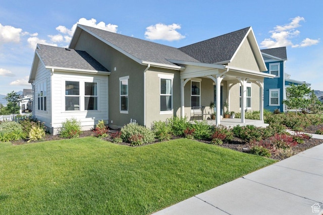 11449 S Bingham Rim Rd, South Jordan, UT 84009 - view of front of home featuring a porch, a front lawn, stucco siding, and roof with shingles