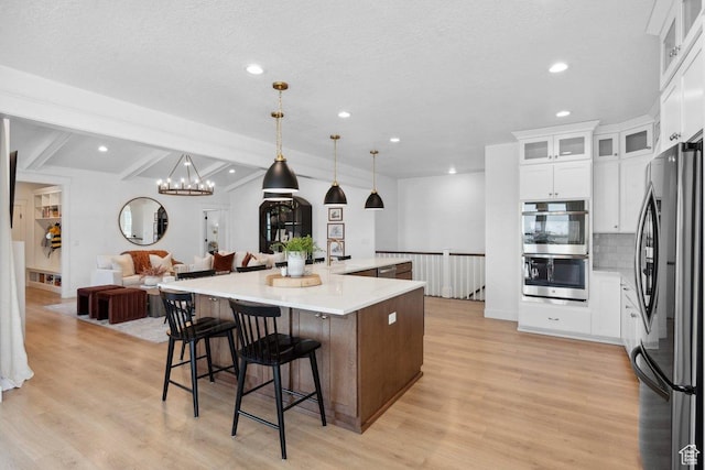 11449 S Bingham Rim Rd, South Jordan, UT 84009 - kitchen with appliances with stainless steel finishes, recessed lighting, open floor plan, light wood-style floors, and tasteful backsplash