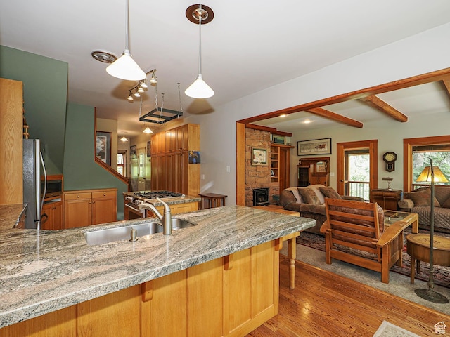 2137 N Pinecrest Canyon Rd Unit 35, Emigration Canyon, UT 84108 - kitchen featuring freestanding refrigerator, open floor plan, light wood-style floors, light stone counters, and beamed ceiling