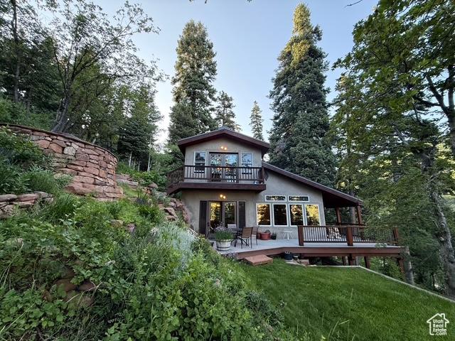 2137 N Pinecrest Canyon Rd Unit 35, Emigration Canyon, UT 84108 - back of house with a deck, a yard, and stucco siding