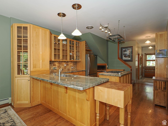 2137 N Pinecrest Canyon Rd Unit 35, Emigration Canyon, UT 84108 - kitchen with appliances with stainless steel finishes, wood finished floors, tasteful backsplash, a peninsula, and glass insert cabinets