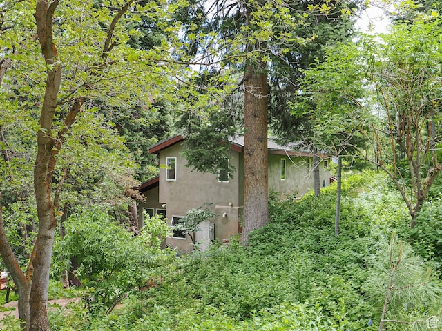 2137 N Pinecrest Canyon Rd Unit 35, Emigration Canyon, UT 84108 - view of home's exterior with stucco siding and a forest view
