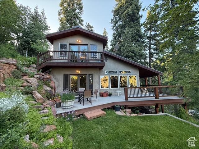 2137 N Pinecrest Canyon Rd Unit 35, Emigration Canyon, UT 84108 - rear view of property with stucco siding, a yard, a wooden deck, and a patio area