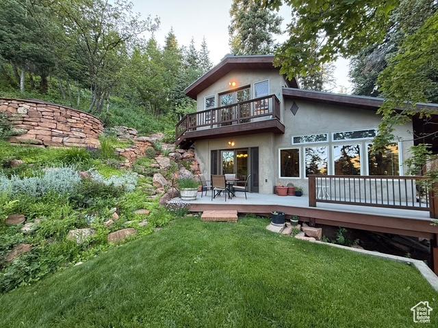 2137 N Pinecrest Canyon Rd Unit 35, Emigration Canyon, UT 84108 - rear view of property with stucco siding, a balcony, a lawn, and a wooden deck