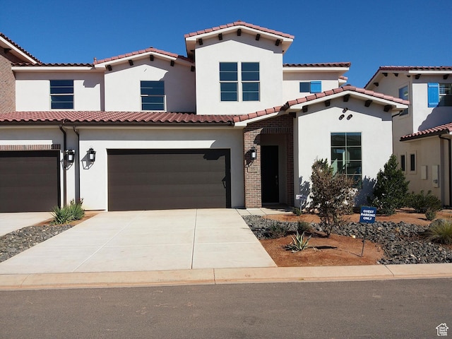3780 W Arcadia Dr Unit 25, Santa Clara, UT 84765 - mediterranean / spanish home featuring an attached garage, stucco siding, driveway, and a tile roof