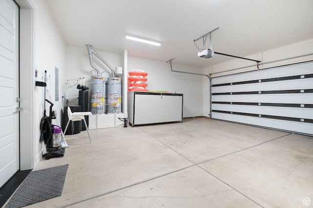 3780 W Arcadia Dr Unit 25, Santa Clara, UT 84765 - garage with fridge, secured water heater, and a garage door opener