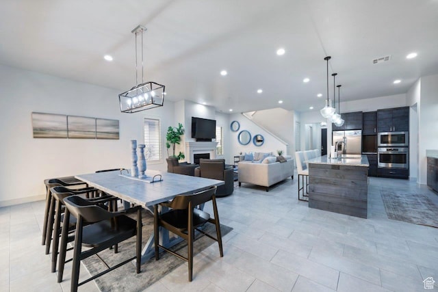 3780 W Arcadia Dr Unit 25, Santa Clara, UT 84765 - dining area featuring recessed lighting, a fireplace, and a chandelier