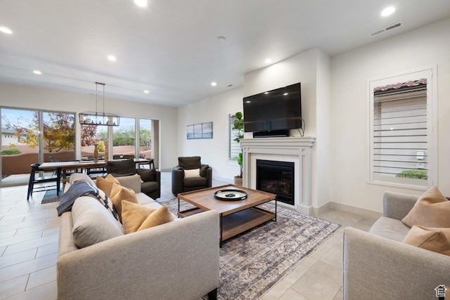 3780 W Arcadia Dr Unit 25, Santa Clara, UT 84765 - living area with recessed lighting, a glass covered fireplace, a chandelier, and light tile patterned floors