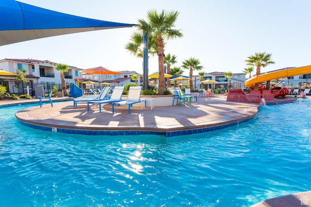 3780 W Arcadia Dr Unit 25, Santa Clara, UT 84765 - community pool with a water slide, a residential view, and a patio area