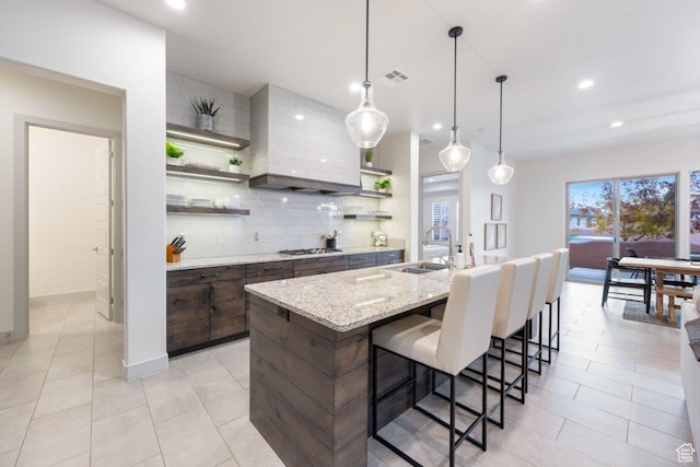3780 W Arcadia Dr Unit 25, Santa Clara, UT 84765 - kitchen with open shelves, decorative backsplash, a breakfast bar, stainless steel gas cooktop, and recessed lighting