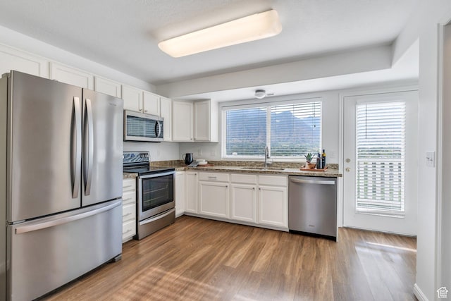 1747 S 750 E, Orem, UT 84097 - kitchen with stainless steel appliances, white cabinetry, dark wood finished floors, and stone countertops