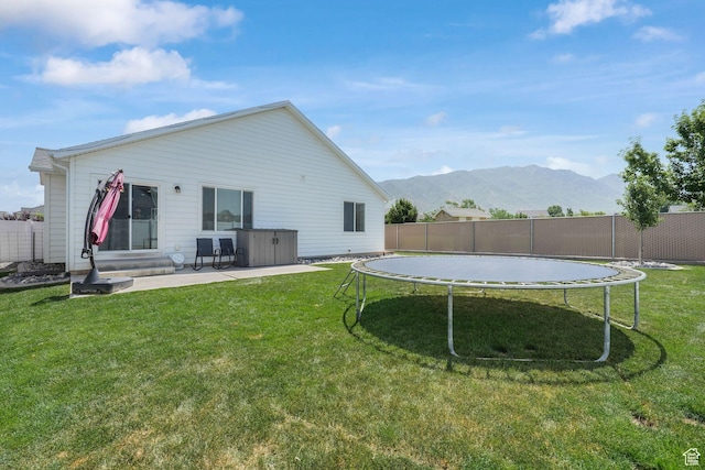 893 N 300 W, Santaquin, UT 84655 - rear view of house with a trampoline, a mountain view, and a patio