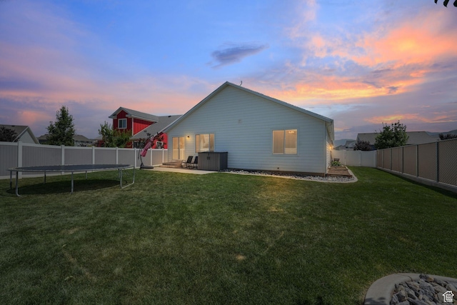 893 N 300 W, Santaquin, UT 84655 - back of property at dusk with a trampoline, a fenced backyard, and a patio area