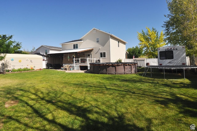 2857 W 2250 N, Clinton, UT 84015 - rear view of house with a trampoline and a covered pool